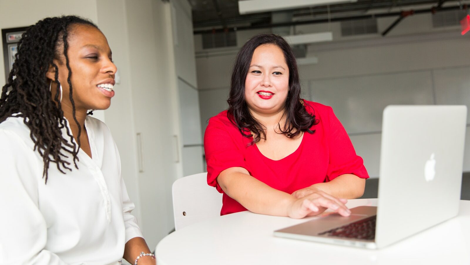Woman Wearing Red Top Holding Silver Macbook