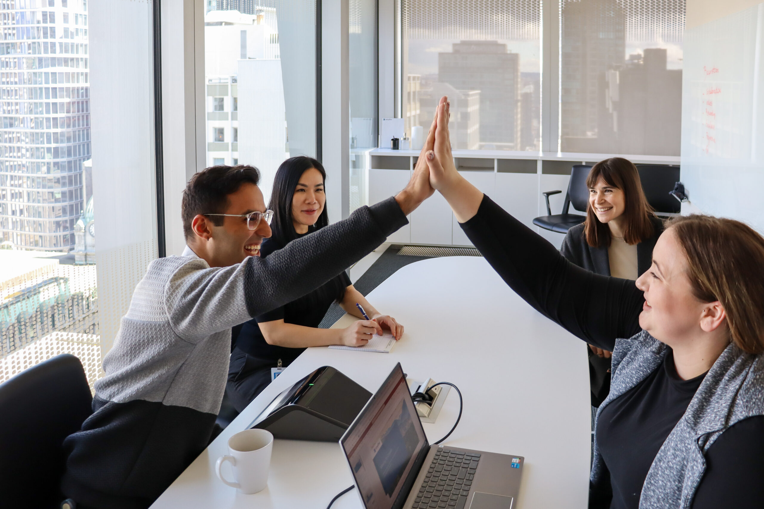 team members doing a high-five