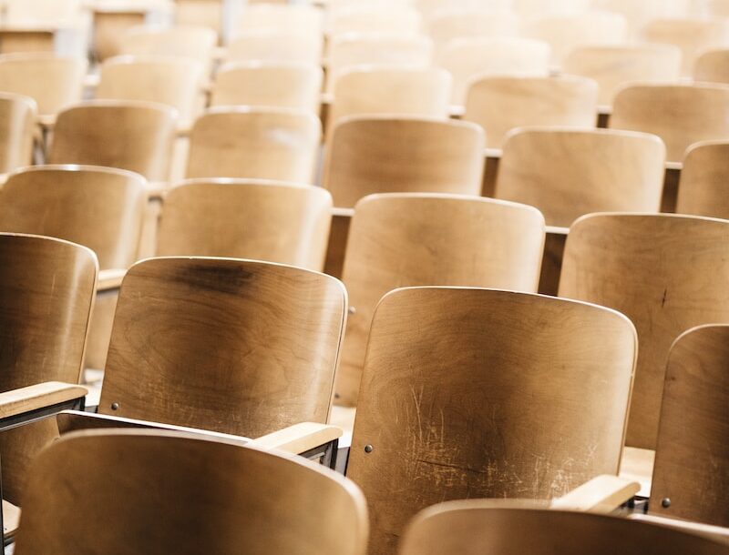 vacant brown wooden chair at stadium