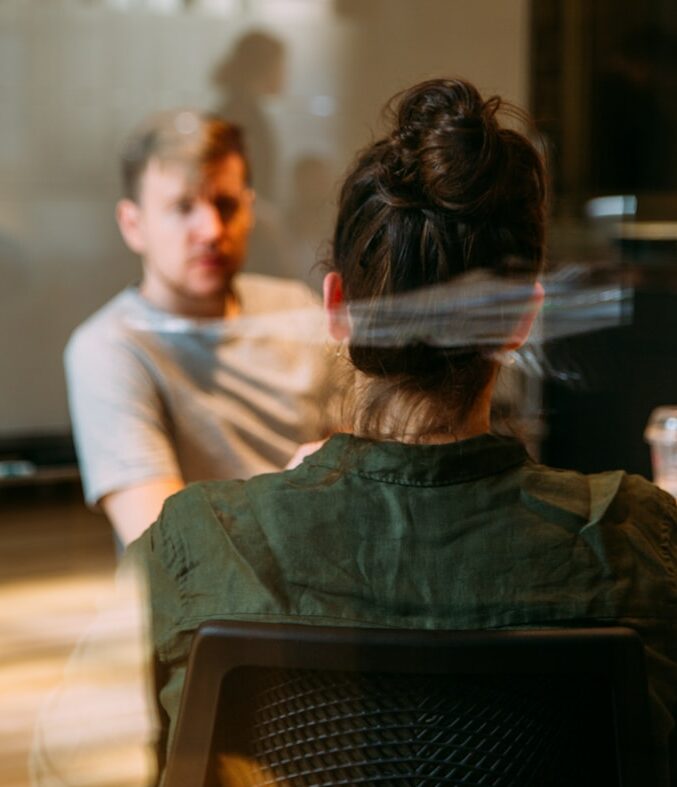 person sitting in a chair in front of a man