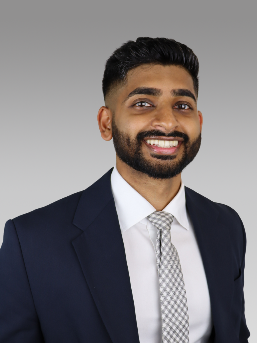 Headshot of Nicholas, a CPA specializing in assurance and accounting services, wearing business attire and smiling against a neutral background.